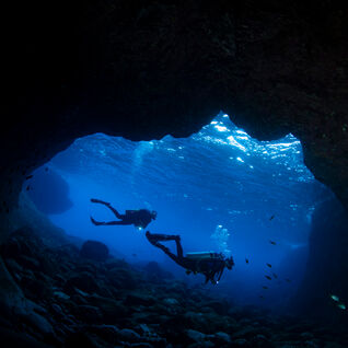 Two divers in an underwater cave