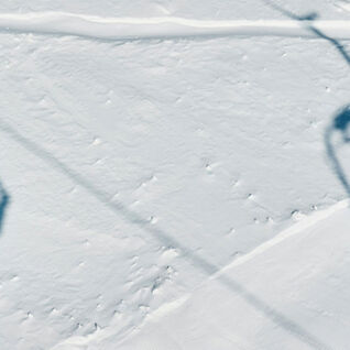 Two ski lifts silhouetted