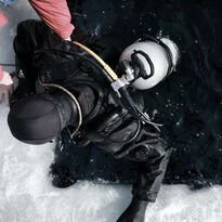 Person diving in a dry suit in icy water