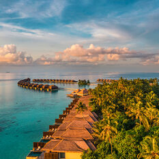 Aerial view of luxury resort in Maldives at sunset
