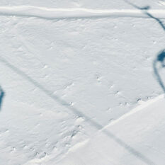Two ski lifts silhouetted