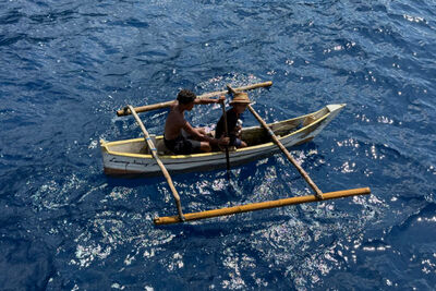 Two men on a wooden rowing boat