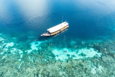 Boat and divers in Wakatobi National Park, Indonesia.