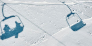 Two ski lifts silhouetted