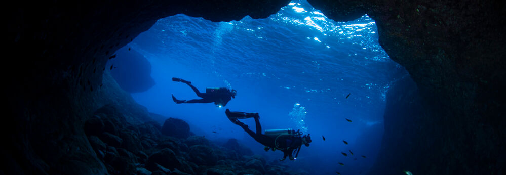 Two divers in an underwater cave