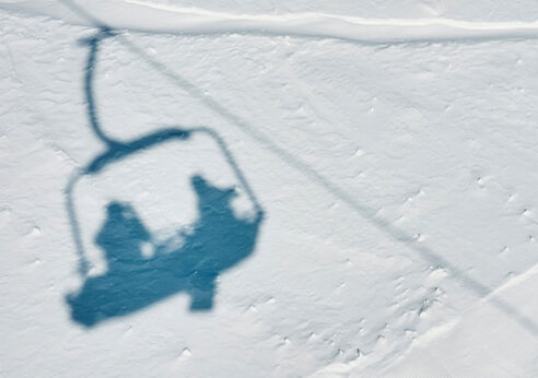 Two ski lifts silhouetted